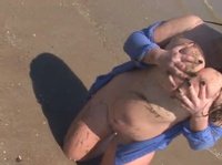 A young BBW is teasing guys with her huge tits on the beach
