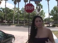 A sexy brunette flashes her little pussy in the street