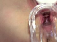 A hot blonde girl brings herself to a crazy orgasm on the table using a vibrator and a speculum