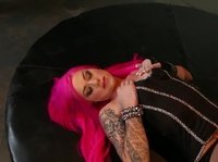 A pink-haired beauty is fucking her pussy with a new toy